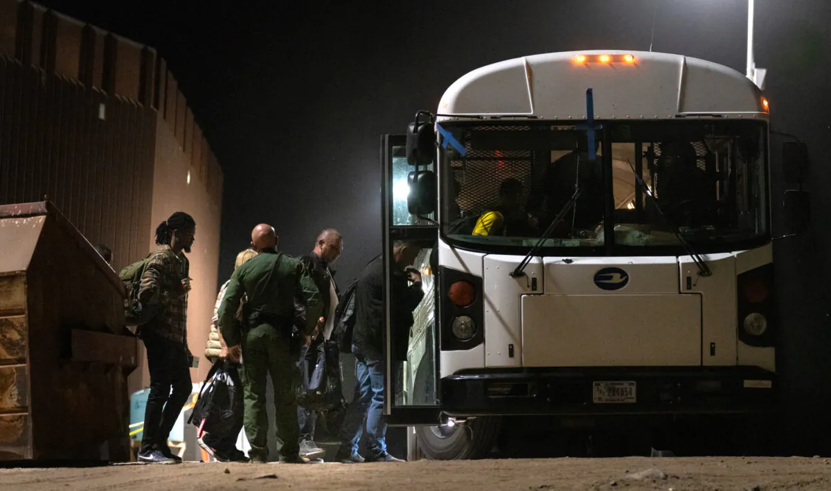 Người nhập cư trái phép chuẩn bị được chở bằng xe buýt đến các cơ sở giải quyết thủ tục của Lực lượng Tuần tra Biên giới ở Yuma, Arizona, hôm 18/05/2023. (Ảnh: John Fredricks/The Epoch Times)