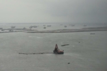 Sà lan bên cạnh các điểm khai thác dưới mưa ở Vịnh Manila, Philippines, hôm 02/08/2023. (Ảnh: Aaron Favila/AP Photo)