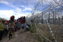 Migrants await to enter and seek asylum in El Paso, Texas, from Ciudad Juarez, Chihuahua, in Mexico, on April 2, 2024. (Christian Monterrosa/AFP via Getty Images)